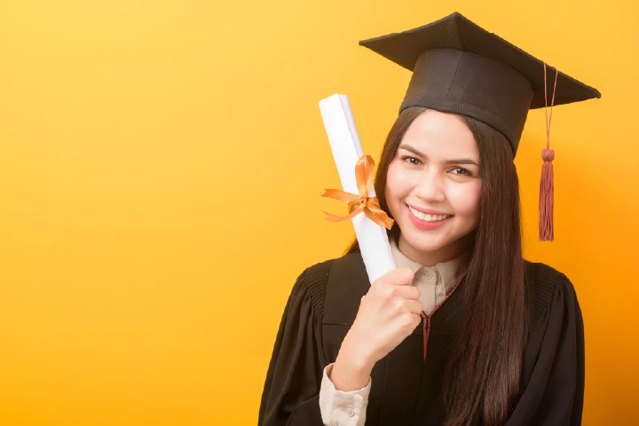 A happy graduate wearing a cap and holding a diploma while celebrating academic success, demonstrating how the Top Travel & Tourism Courses help students build a rewarding future in the tourism industry.